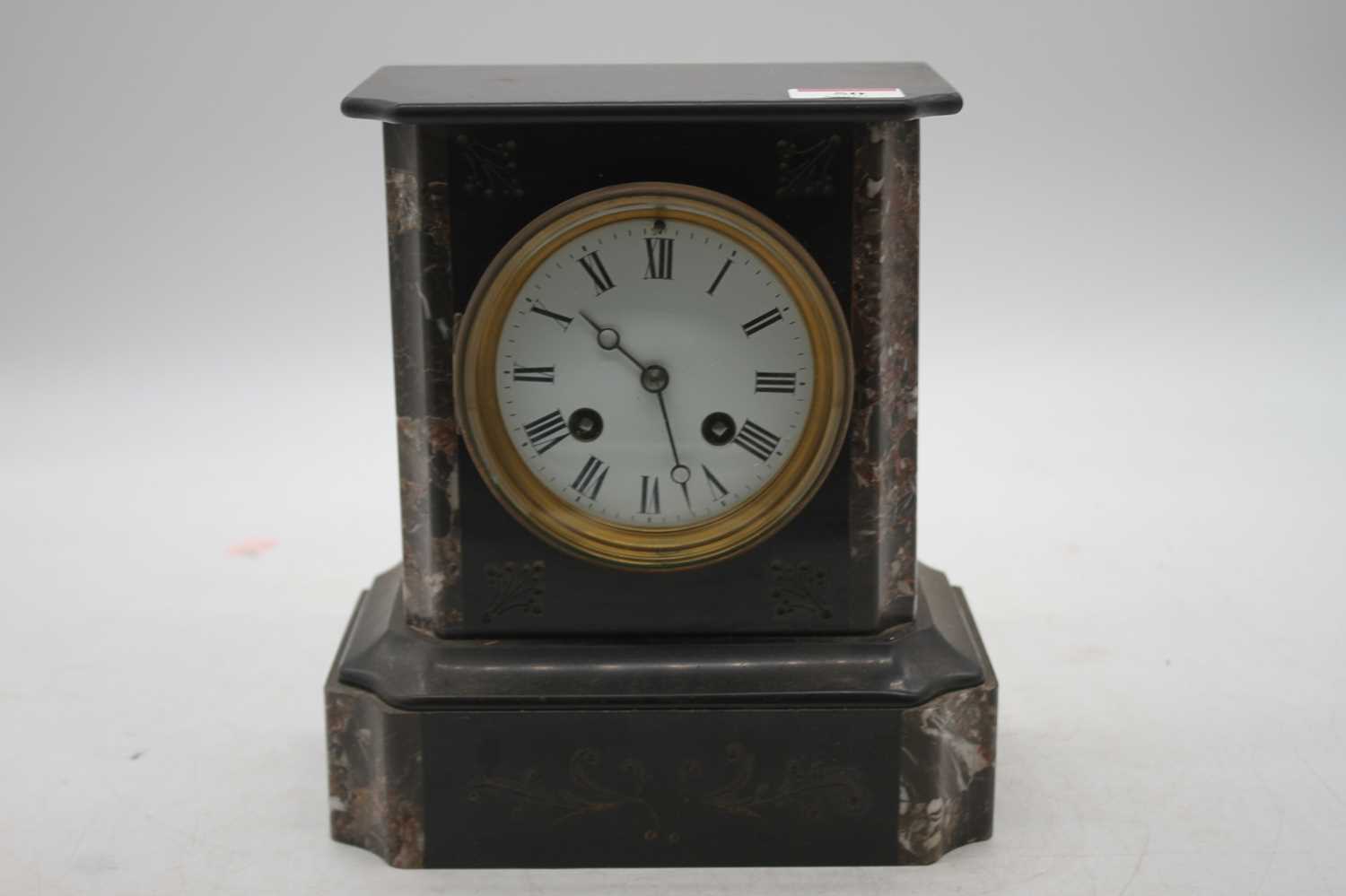 A late Victorian black slate and marble cased mantel clock having a circular enamel dial with