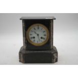 A late Victorian black slate and marble cased mantel clock having a circular enamel dial with