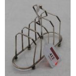 A late Victorian silver toast-rack, having four arched divisions and loop handle, on ball feet, 1.