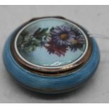 An early 20th century French silver gilt and guilloche enamel pill box, the hinged lid enamel