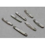 A collection of seven Victorian and later fruit knives, each having a folding silver blade and