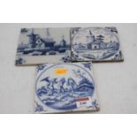 A collection of three 18th and 19th century Delft blue and white glazed tiles, the largest 13 x