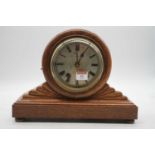 A Victorian oak cased drum head mantel clock having a circular silvered dial with Roman numerals