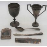 A collection of silverware, to include two trophy cups, silver clad desk stand, flatware etc