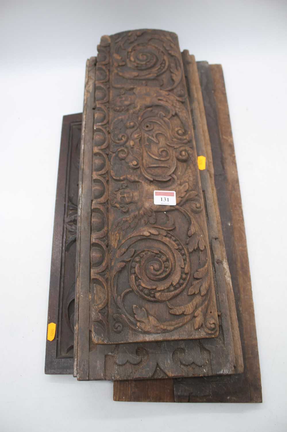 A 17th century oak panel, the central reserve dated 1639, flanked by winged putti, 17 x 58cm;