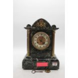 A late Victorian marble cased mantel clock of architectural form, having an enamelled chapter ring