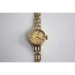 A lady's Bulova 9ct gold cased quartz bracelet watch, having signed champagne dial, 10.8g, case