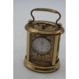 A Halcyon Days enamel decorated miniature carriage clock, h.6.5cm (handle down)