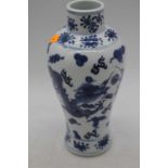 A Chinese blue and white porcelain vase, of baluster form, decorated with dragons chasing a pearl,