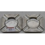 A pair of George V silver ashtrays, of canted square shape with engine turned decoration, maker