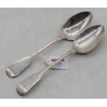 A pair of Victorian Irish silver serving spoons, in the Hanoverian pattern, each terminal engraved