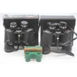 A pair of Tasco 7 x 50 binoculars, cased; together with two further pairs of binoculars