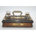 A Victorian walnut and ebonised desk stand, having brass mounts with twin glass inkwells and