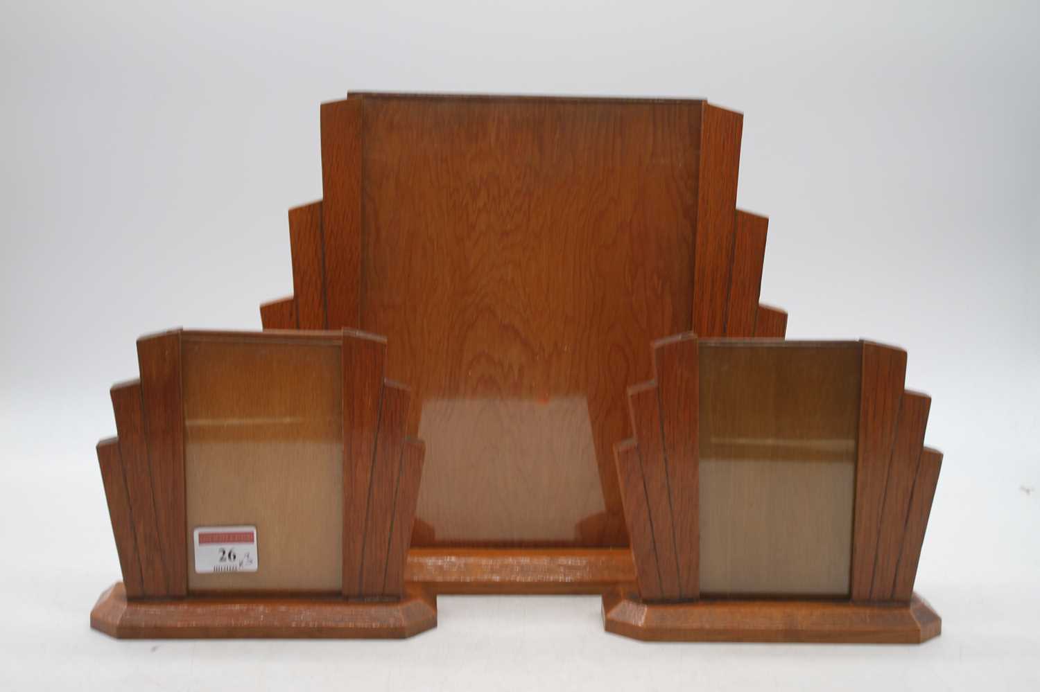 An Art Deco oak photo frame of shaped angular form, width 31cm, together with a pair of smaller