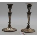 A pair of Victorian loaded silver Adam style table candlesticks, Sheffield 1898, h.21cmHeavily