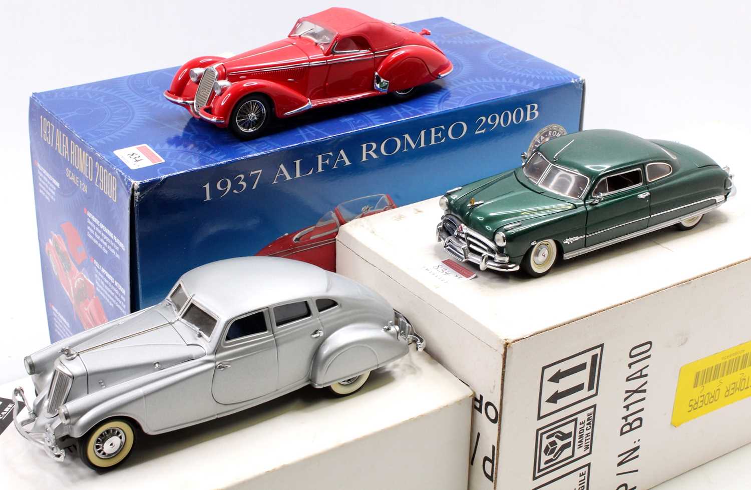 A Franklin Mint 1/24 scale boxed diecast group to include a 1937 Alfa Romeo 2900B saloon finished in