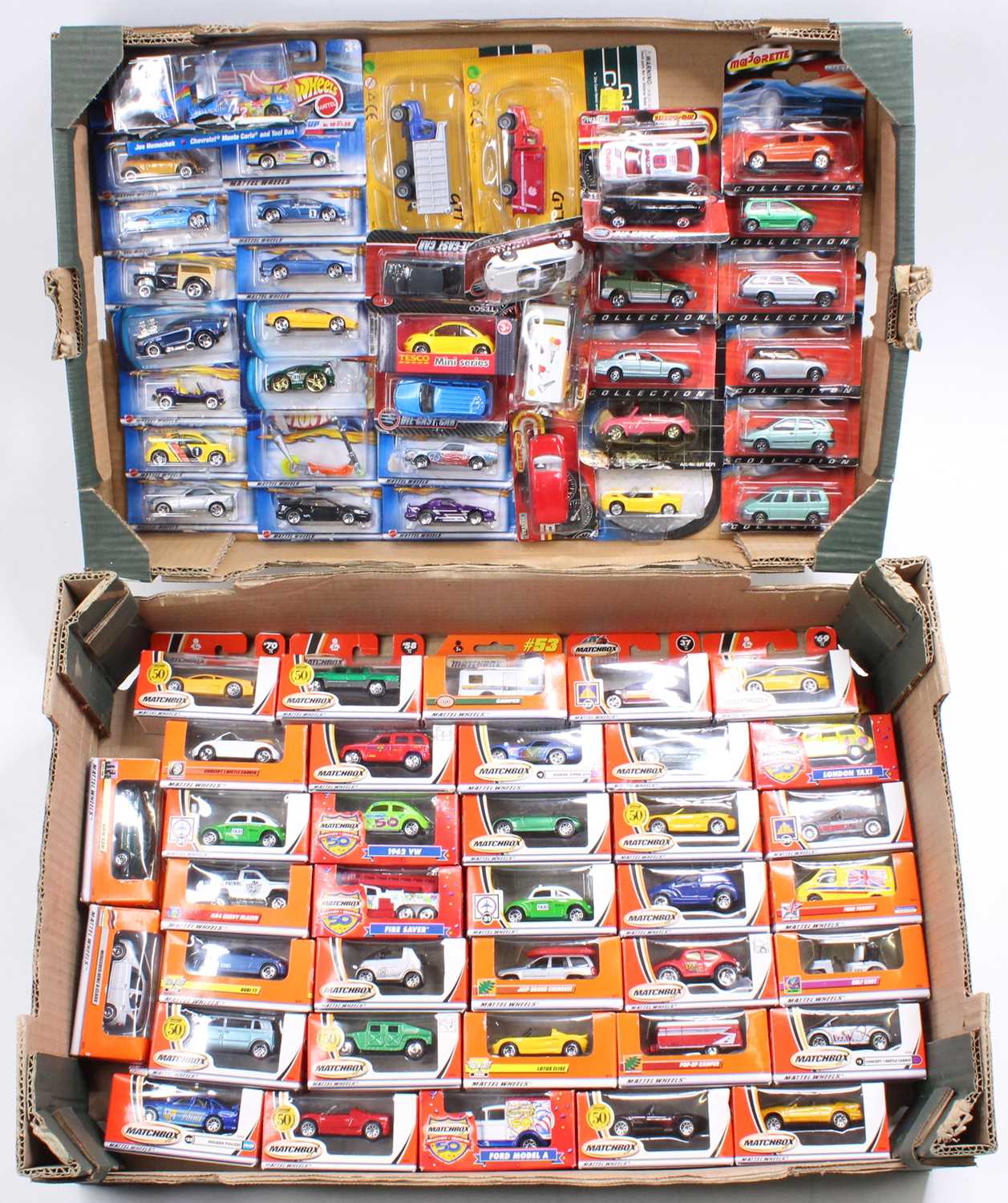 Two trays containing a collection of various Matchbox Hotwheels and Tesco release boxed and carded