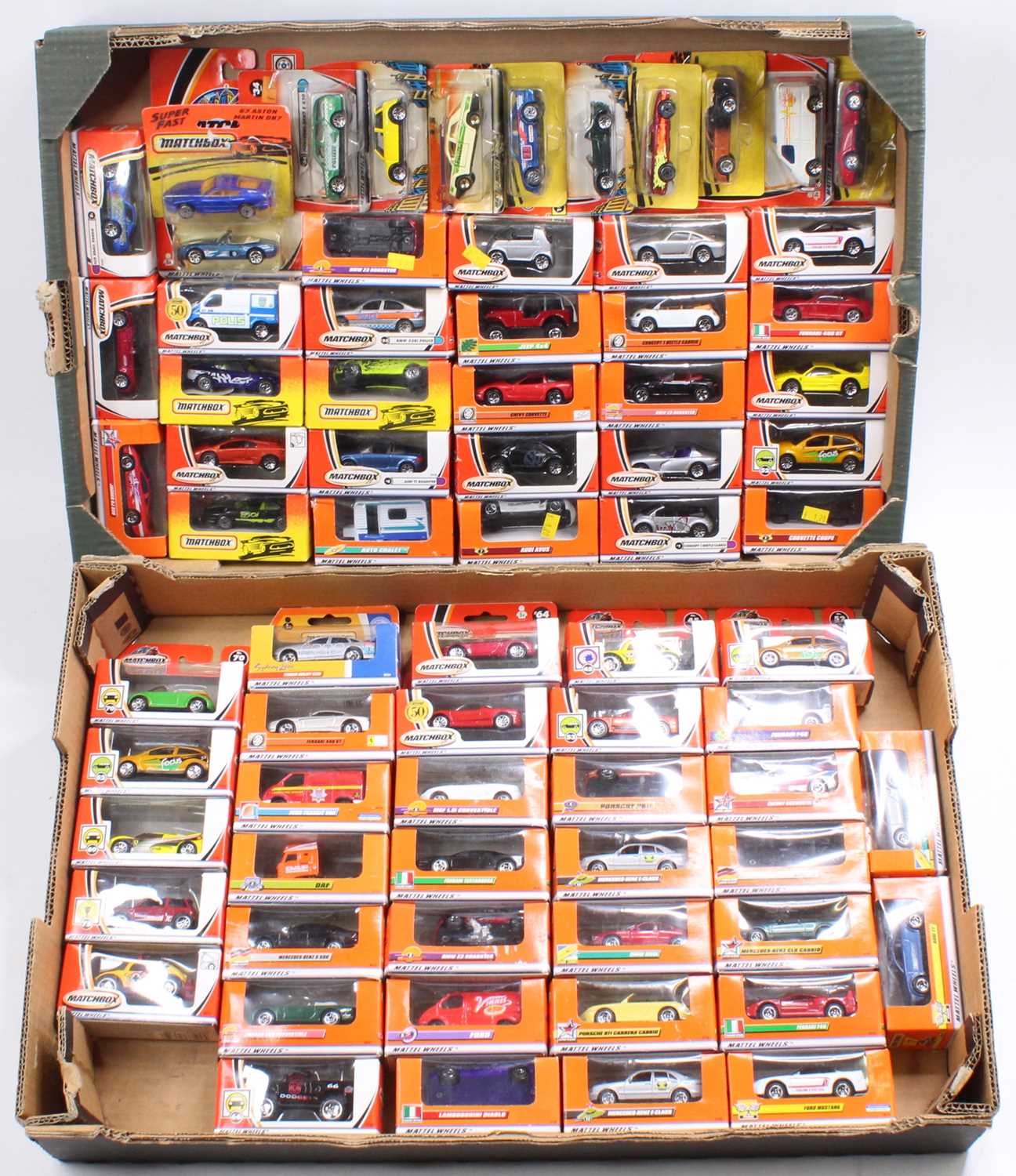 Two trays containing a large collection of various Matchbox Mattel wheels, boxed and carded