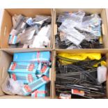 Four boxes containing a large and extensive collection of 00 and H0 scale track, points, underlay