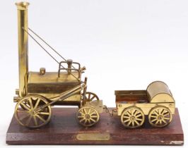 A brass static display model on wooden base depicting the Stephenson's Rocket, base length 33cm, max
