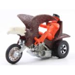 A vintage Hot Wheels Rrrumblers Bold Eagle motorcycle with an orange plastic rider, the riders arm