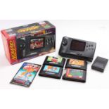 A boxed Sega Genesis Nomad hand-held video game console, sold with a quantity of game cartridges