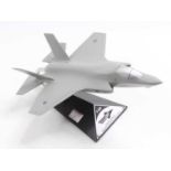 A wooden and resin scale model of a F-35B Lockheed Martin by JSF positioned on the original