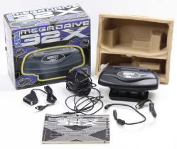 A Sega Megadrive 32X console add-on, housed in the original card box, with instruction leaflet