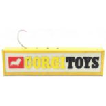 A vintage Corgi Toys illuminating shop sign comprising a metal case with a plastic front and Corgi