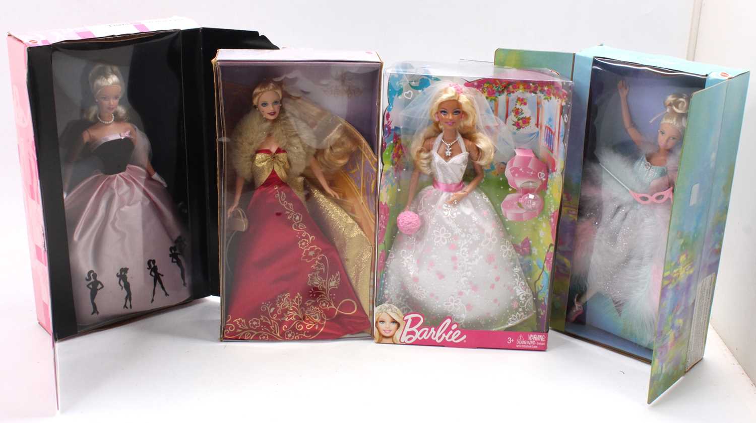 4 boxed Mattel Barbie Dolls, with examples including Timeless Silhouette Barbie, Ballet Masquerade
