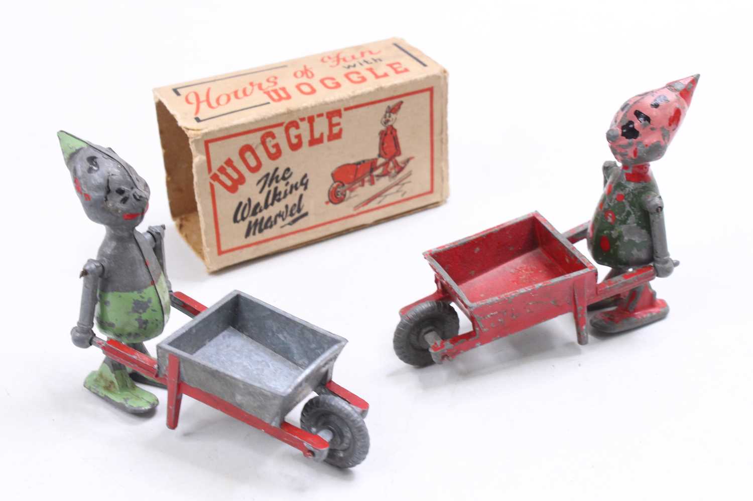 A boxed Woggle - The Walking Marvel, comprising of figure with wheelbarrow, together with one