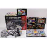 A Nintendo N64 boxed console, complete with two grey Nintendo 64 controllers, two rumble packs,