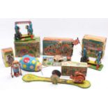 A collection of vintage boxed tinplate mechanical and clockwork children's toys including a