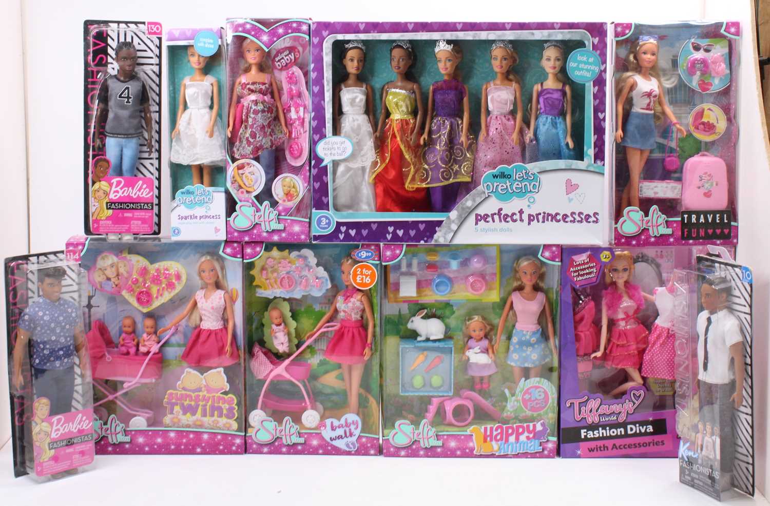 A collection of boxed children's dolls, with specific examples including a Steffi Baby Walk Doll,