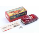 Schuco No. 4012 tinplate and clockwork radio car, maroon body, red interior, 2 clockwork motors to