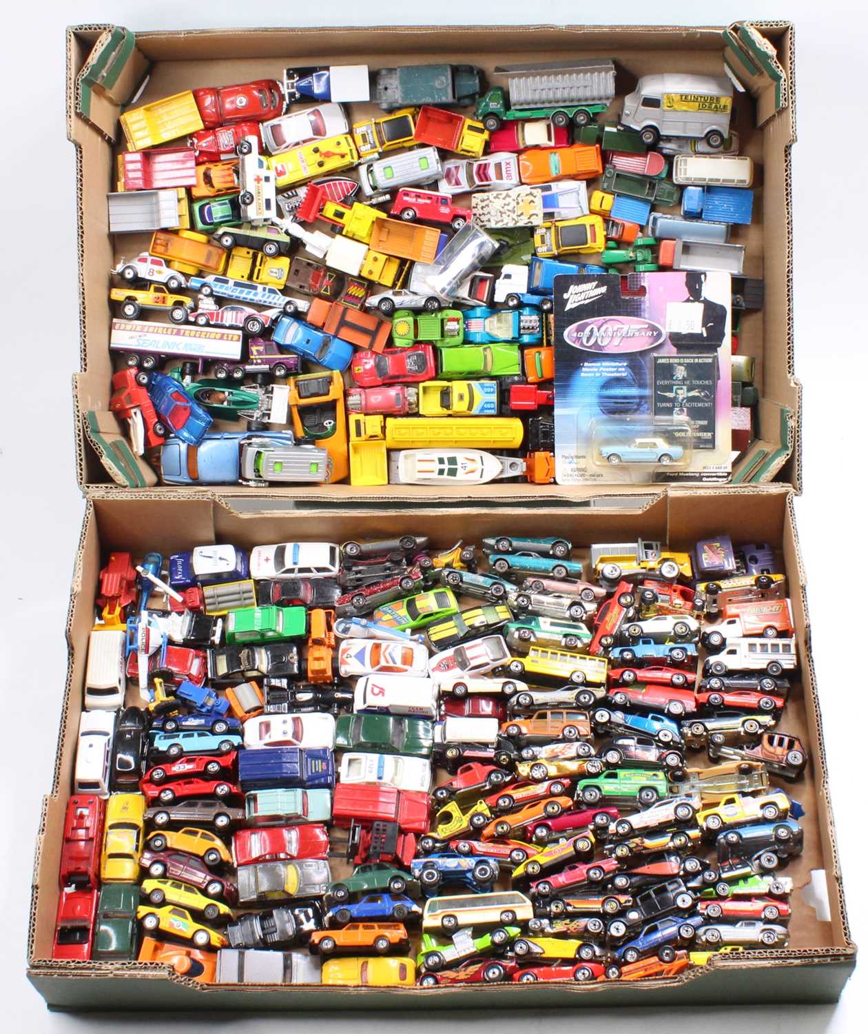 Two trays containing a collection of mixed Matchbox Hotwheels and similar scale modern release and