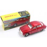 A Dinky Toys No. 156 Saab 96 saloon, comprising of metallic red body with white interior and spun