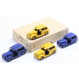An original Dinky Toys trade box of No. 40H six Austin taxis containing two yellow and two dark blue