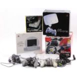 A collection of Play Station PSone consoles, LCD screens, multi-tap control panel, and racing wheel,