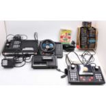 A large box containing a collection of Coleco Vision consoles, expansion packs, steering wheels,