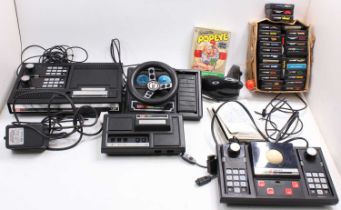 A large box containing a collection of Coleco Vision consoles, expansion packs, steering wheels,