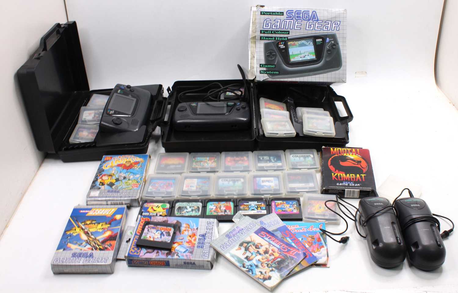 A collection of Sega Game Gear, hand-held video game consoles, together with a large collection of