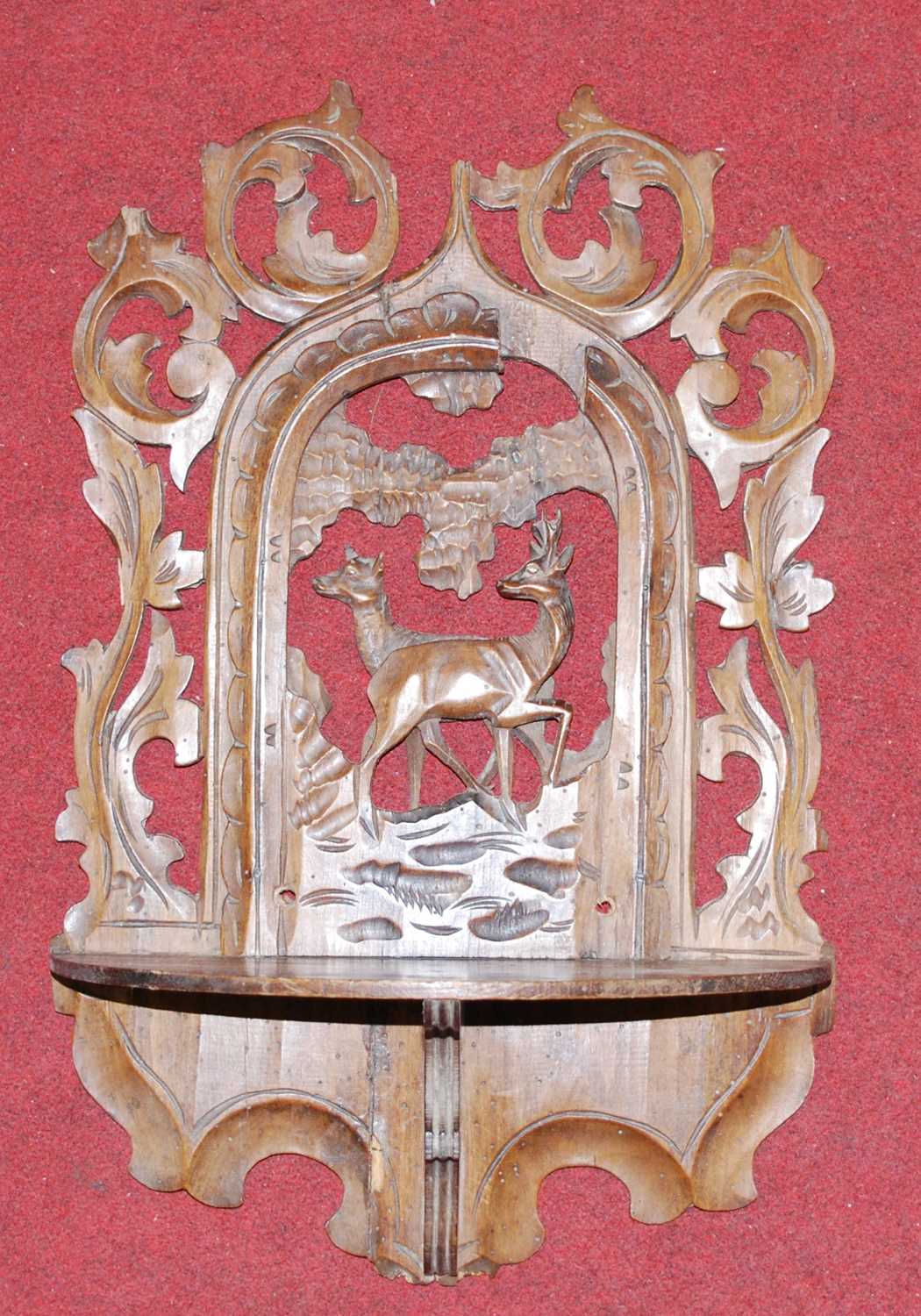 A continental carved pine wall bracket, decorated with deer