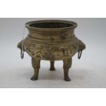 A Chinese brass tripod censer, flanked by zoomorphic handles, zhuanshu seal mark to the underside,