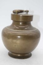 An Indian brass holy water vessel, of baluster form, height 21cm including handle