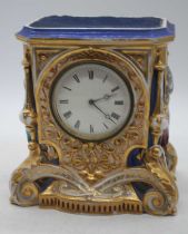 A 19th century porcelain cased mantel clock, the dial showing Roman numerals, height 20.5cm