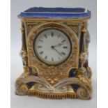 A 19th century porcelain cased mantel clock, the dial showing Roman numerals, height 20.5cm