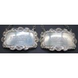 A pair of Victorian style silver and embossed decanter collars, annotated for Brandy and Sherry, w.