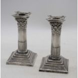 A pair of Victorian Mappin & Webb silver table candlesticks, each in the form of a corinthian