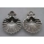 A pair of early 20th century white metal shell shaped butter dishes, stamped Alpaca, 1.6oz